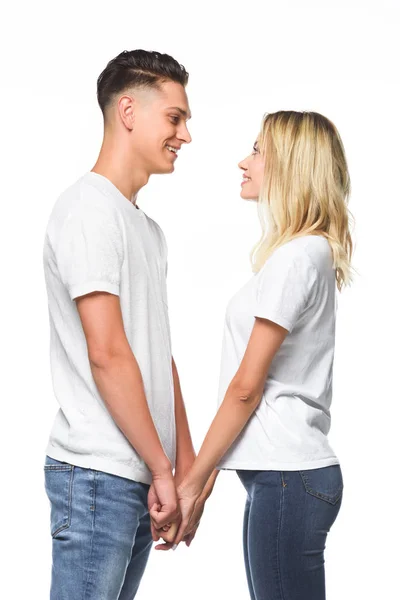 Side view of couple holding hands and looking at each other isolated on white — Stock Photo