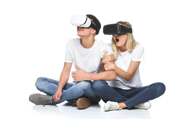Shocked couple using virtual reality headsets isolated on white — Stock Photo