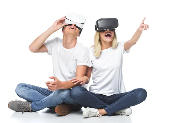 Couple using virtual reality headsets isolated on white, girlfriend pointing on something — Stock Photo