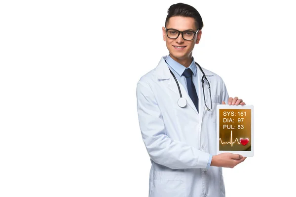 Handsome young doctor holding tablet with heart rate monitor on screen isolated on white — Stock Photo