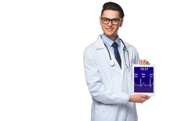 Happy young doctor holding tablet with heart rate monitor on screen isolated on white — Stock Photo