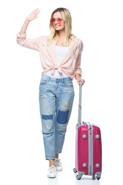 Young travelling woman with luggage waving wih hand isolated on white — Stock Photo