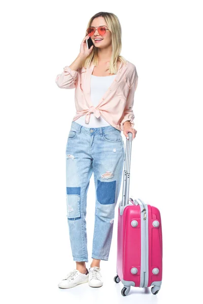 Young travelling woman with luggage talking by phone isolated on white — Stock Photo