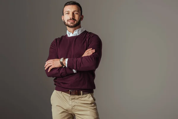 Handsome man posing in burgundy autumn sweater with crossed arms, isolated on grey — Stock Photo
