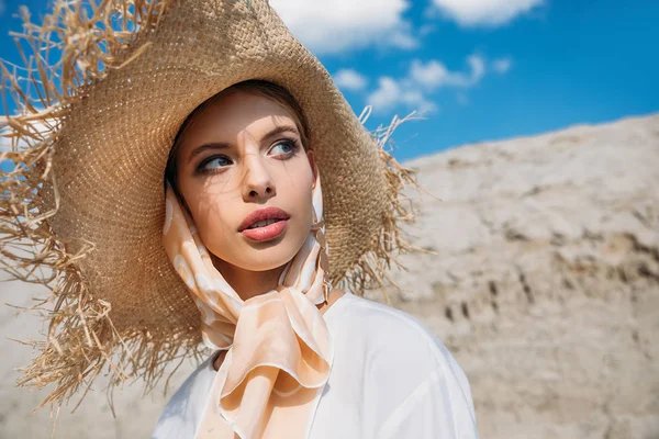 Beautiful stylish young woman posing in trendy silk scarf and straw hat — Stock Photo