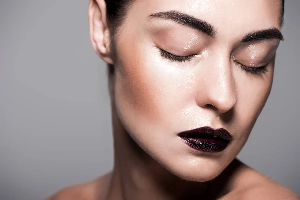 Fashionable girl with black lips and wet face, isolated on grey — Stock Photo