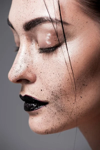 Profile portrait of attractive model with black lips and freckles on face, isolated on grey — Stock Photo