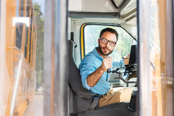 School bus driver losing door with lever and looking back — Stock Photo