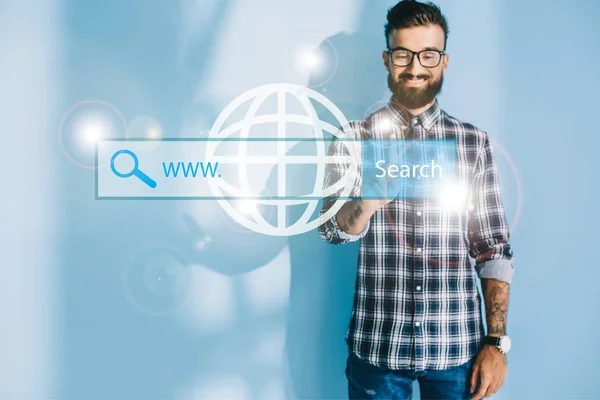 Smiling developer pointing at website search bar — Stock Photo