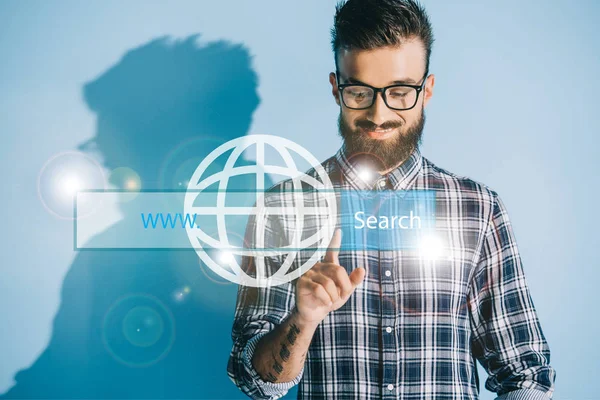 Smiling developer in checkered shirt pointing at website search bar — Stock Photo