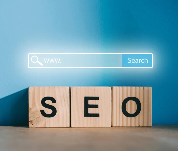 SEO blocks on blue background with website search bar — Stock Photo