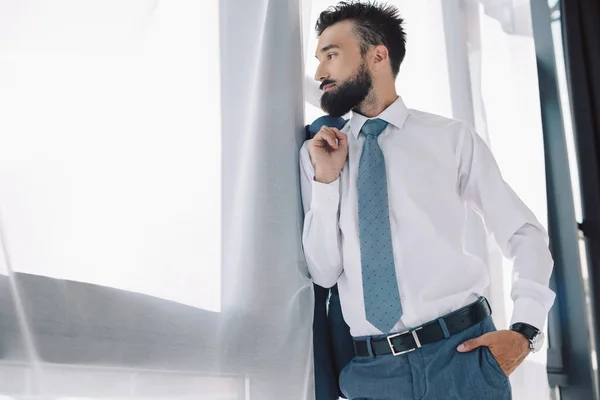 Bearded businessman looking at window in office — Stock Photo