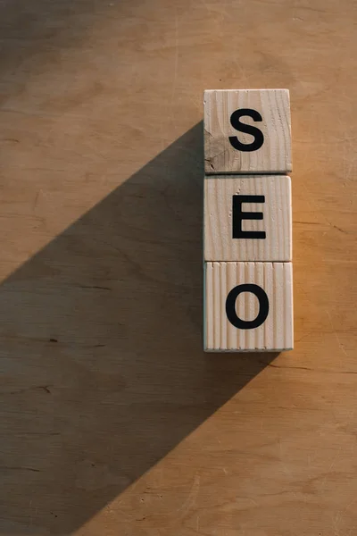 Top view of wooden blocks making SEO word on wooden background — Stock Photo