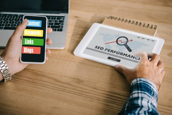 Cropped shot of professional developer using different gadgets with SEO performance — Stock Photo