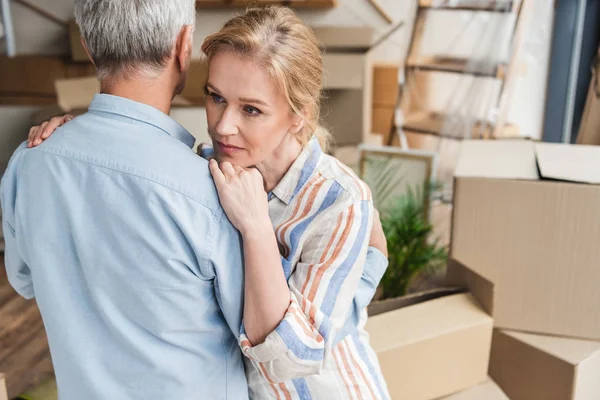 High angle view of elderly couple hugging while moving home — Stock Photo