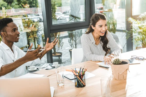 Portrait of multiethnic happy business people working at workplace in office — Stock Photo