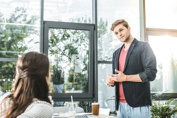 Portrait of concentrated businessman listening to colleague in office — Stock Photo