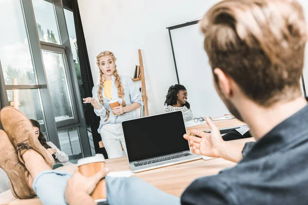 Multicultural business coworkers having conversation during seminar in office — Stock Photo