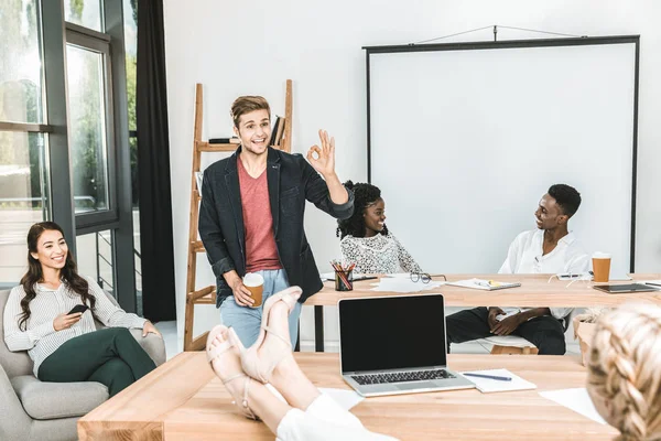 Multicultural young business coworkers during seminar in office — Stock Photo