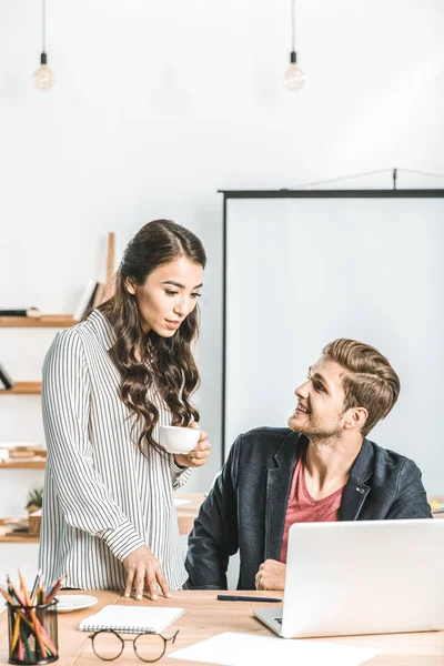 Portrait of multiethnic businesspeople working together on laptop in office — Stock Photo