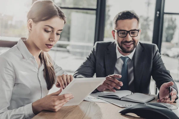 Successful young businessman and businesswoman working together at modern office — Stock Photo