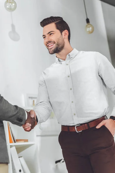 Cropped image of african american and caucasian businessmen shaking hands — Stock Photo