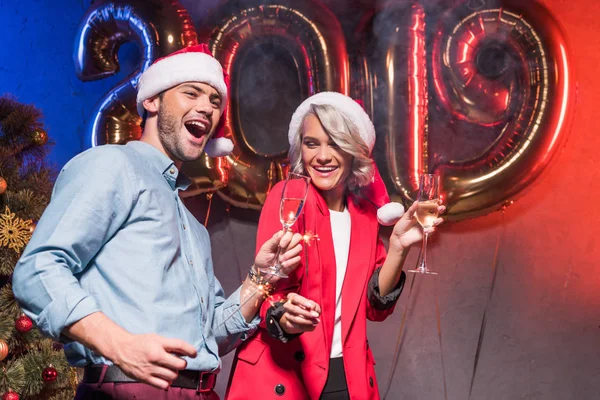 Young businesspeople in santa hats having fun at new year corporate party — Stock Photo
