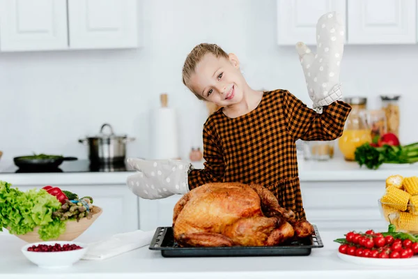 Adorable little child with thanksgiving turkey on tray — Stock Photo