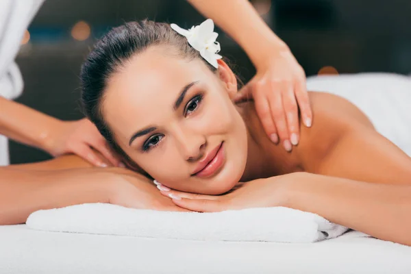Woman relaxing and having massage at spa salon and looking at camera — Stock Photo