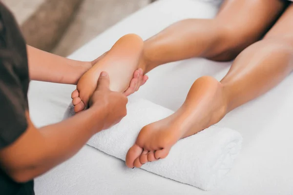Cropped view of woman having feet massage in spa salon — Stock Photo