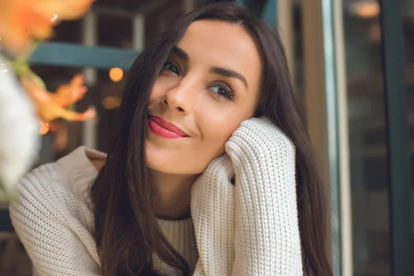 Dreamy young beautiful woman looking away in cafe — Stock Photo