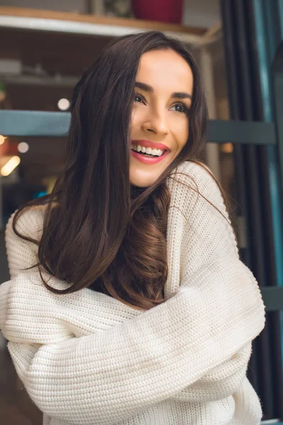 Selective focus of happy beautiful woman looking away in cafe — Stock Photo