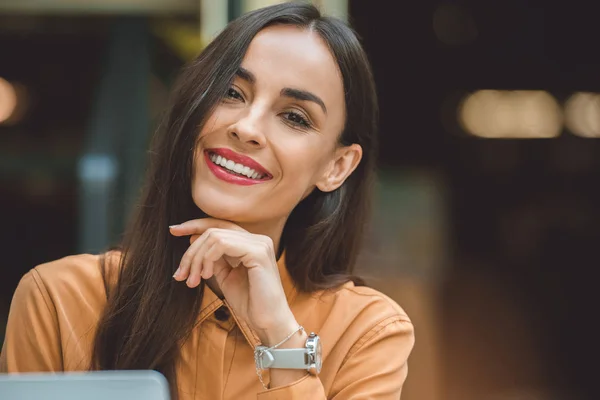 Close up portrait of laughing beautiful woman looking at camera in cafe — Stock Photo