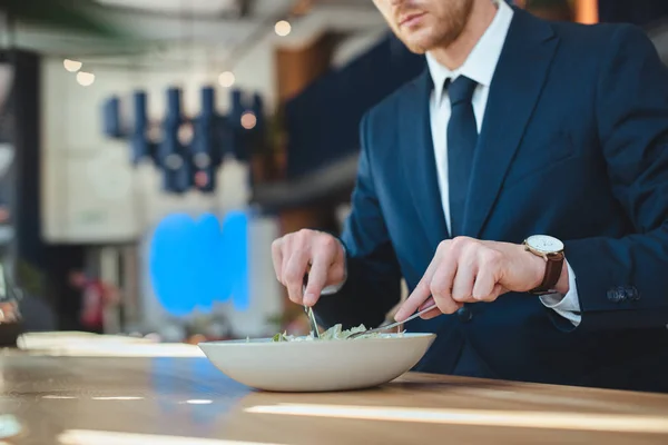 Partial view of businessman at table with served lunch in restaurant — Stock Photo