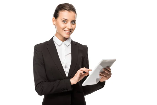 Beautiful young businesswoman using tablet and looking at camera isolated on white — Stock Photo