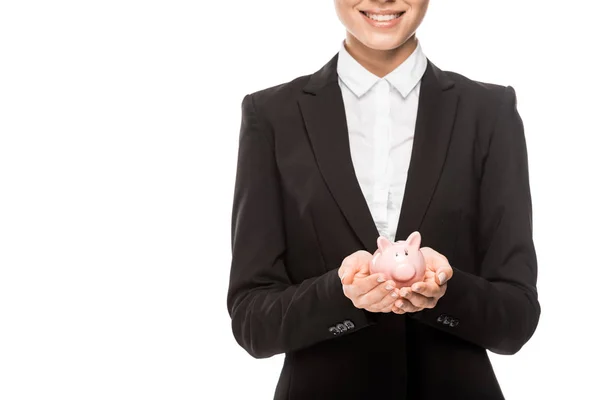 Cropped shot of smiling young businesswoman holding piggy bank isolated on white — Stock Photo