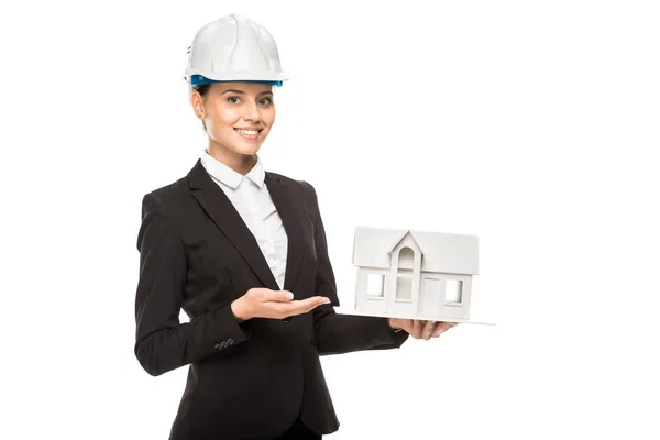 Cropped shot of smiling young female architect holding miniature house model isolated on white — Stock Photo