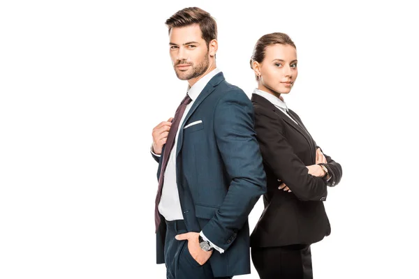 Confident young business partners leaning back to back and looking at camera isolated on white — Stock Photo