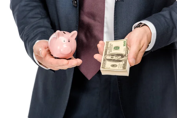 Cropped image of businessman showing piggybank and dollar banknotes isolated on white — Stock Photo