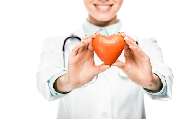 Vista parcial de la joven doctora con estetoscopio sobre el cuello mostrando el símbolo del corazón aislado en blanco - foto de stock