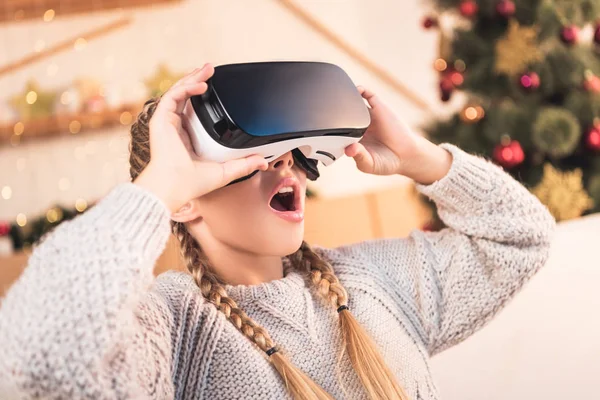Excited preteen child using virtual reality headset at christmastime — Stock Photo