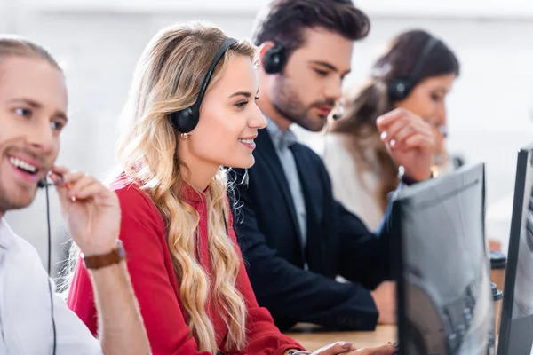 Selective focus of call center operators working at workplace in office — Stock Photo