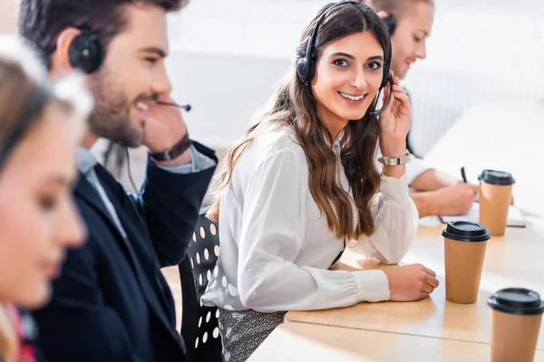 Selective focus of call center operators working at workplace in office — Stock Photo