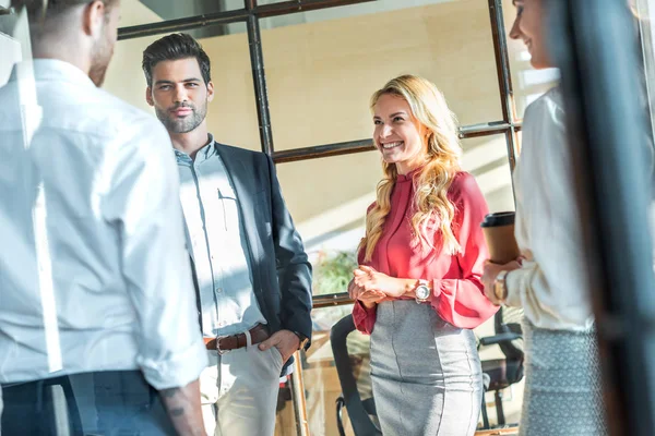 Business colleagues having conversation in hall during coffee break — Stock Photo