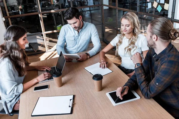 Young business coworkers discussing project during meeting in office — Stock Photo