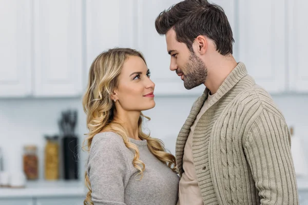 Portrait of girlfriend and boyfriend looking at each other at home — Stock Photo