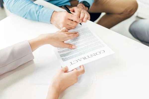 Cropped shot of business colleagues signing contract in office — Stock Photo
