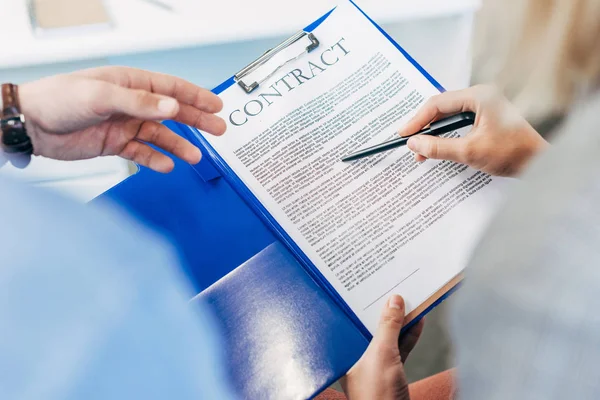 Cropped shot of business colleagues working with contract — Stock Photo