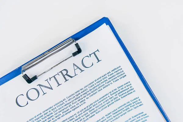 Top view of clipboard with contract on white tabletop — Stock Photo