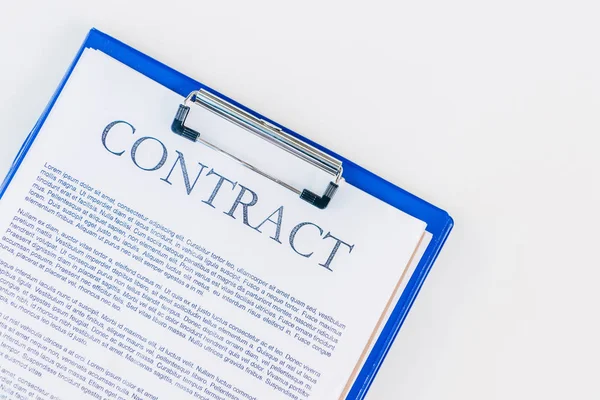 Top view of clipboard with contract on white surface — Stock Photo